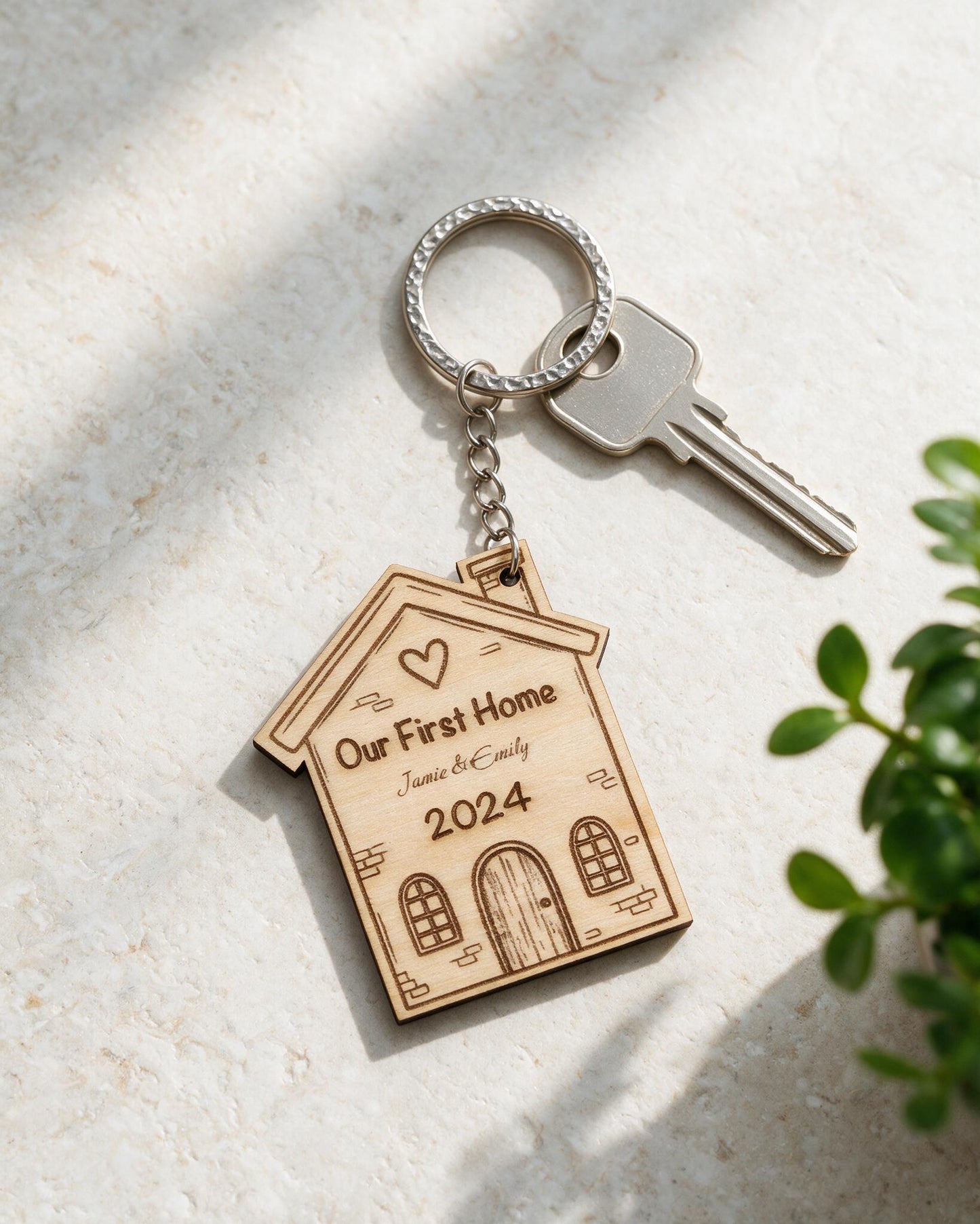 Personalised First Home wooden keyring in a sunlit tabletop scene