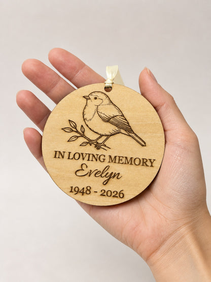 Personalised robin memorial ornament in an adult woman hand for 10 cm scale