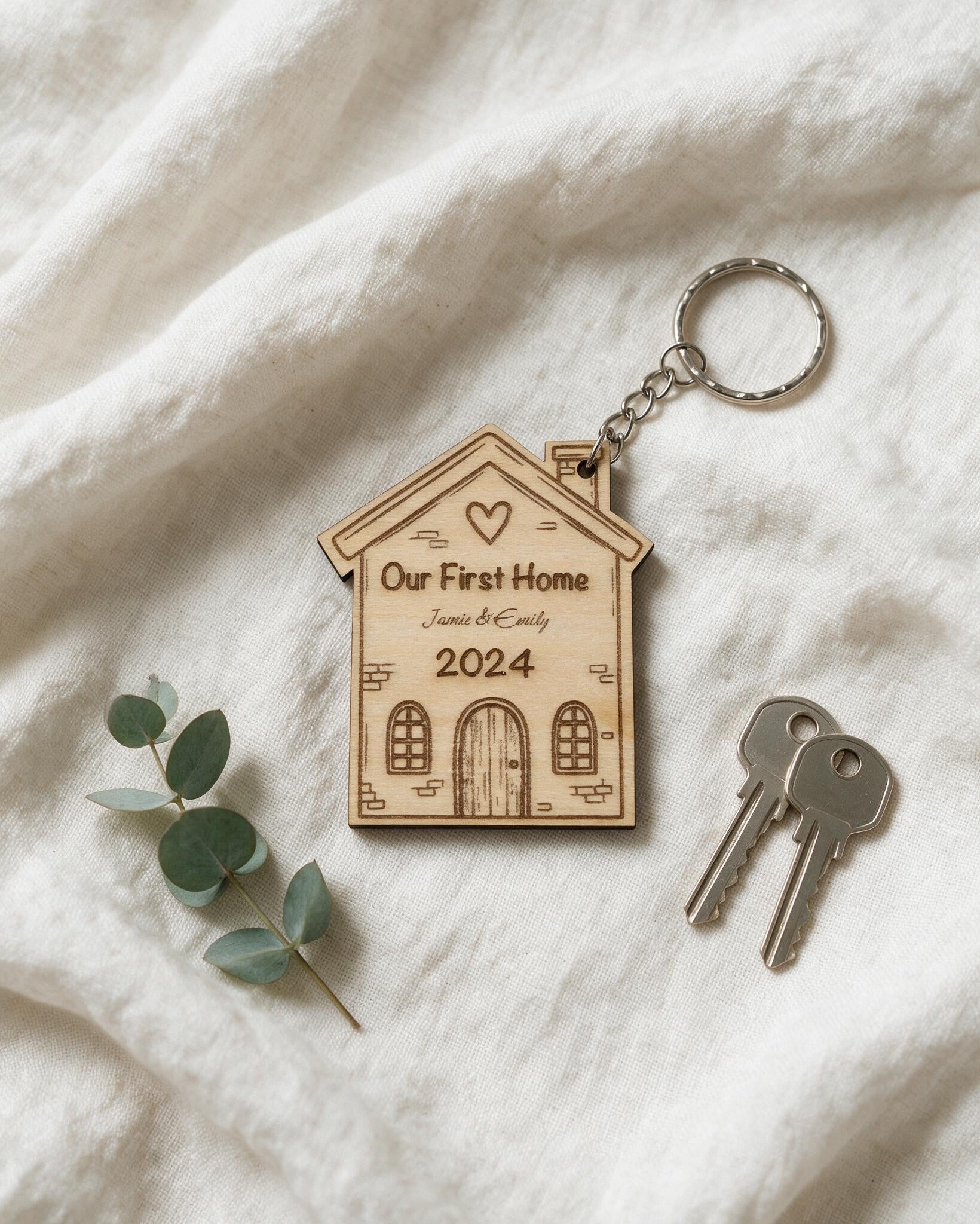 Personalised First Home wooden keyring arranged on ivory linen
