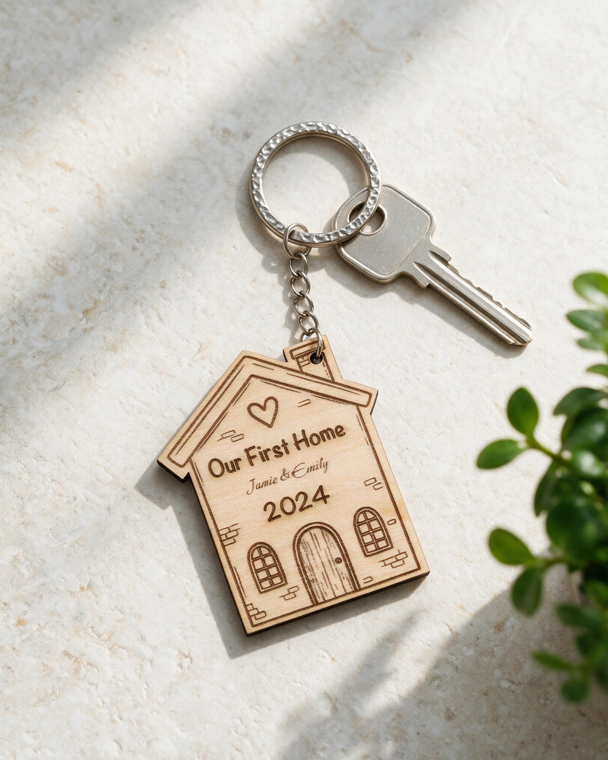 Personalised First Home wooden keyring in a sunlit tabletop scene