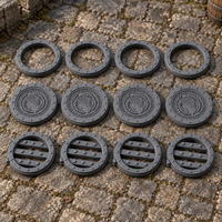 Fantasy Manhole Set 12-piece pack shown in a medieval 28mm tabletop scene, supplied grey and unpainted