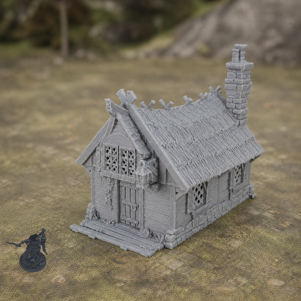 Cottage 28mm terrain with dark grey miniature for scale