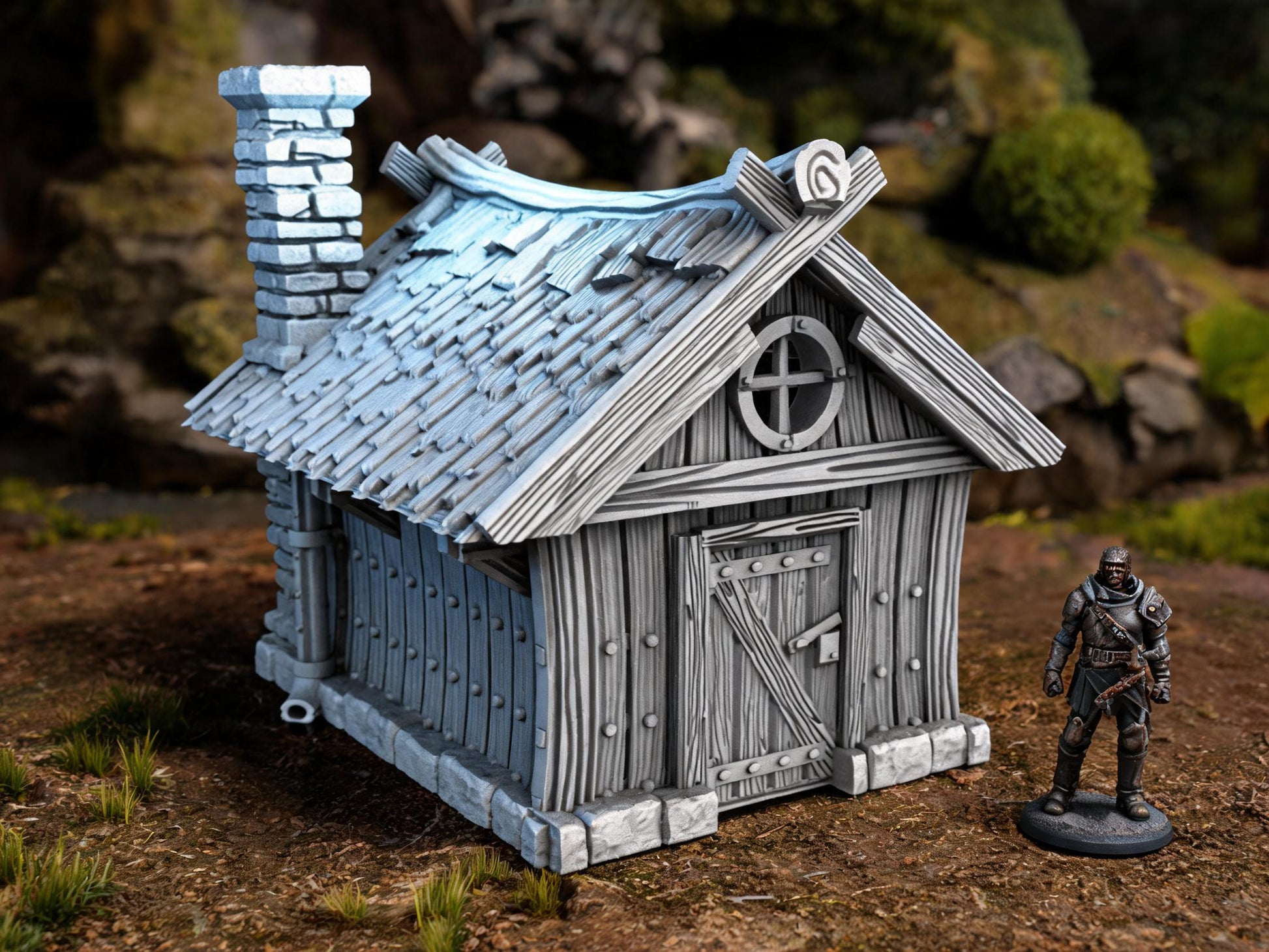 Unpainted Hunters Cabin 28mm terrain with scale miniatures shown for context; miniatures not included