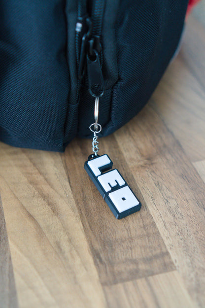 Roblox personalised name keychain on wooden background