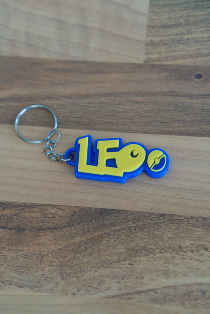 Personalised Pokemon name keychain in blue and yellow 3D printed with Pokeball detail