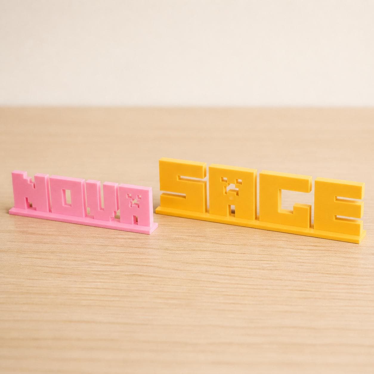Small and Large Nova block letter personalised nameplates shown together for size comparison.
