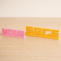 Small and Large Nova block letter personalised nameplates shown together for size comparison.