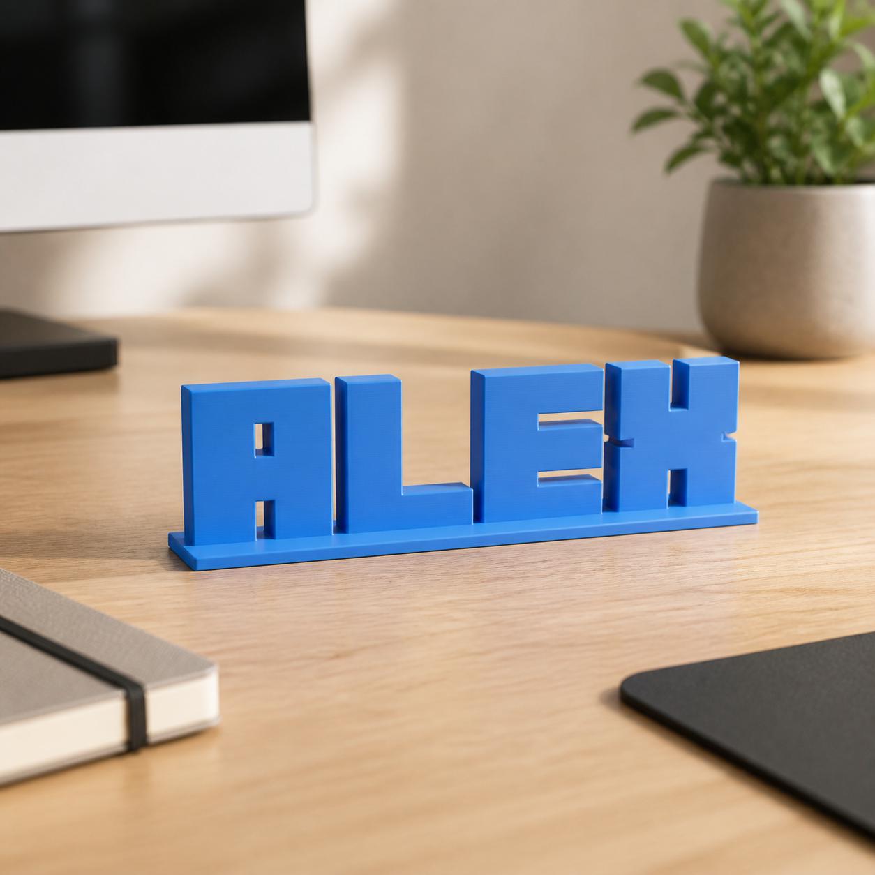Alex block letter personalised nameplate displayed on a modern home-office desk.