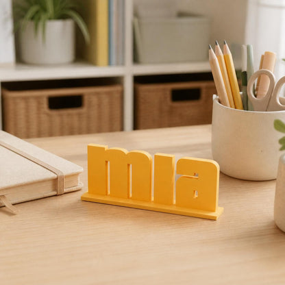 Mia bold arcade personalised nameplate displayed on a teacher's desk.