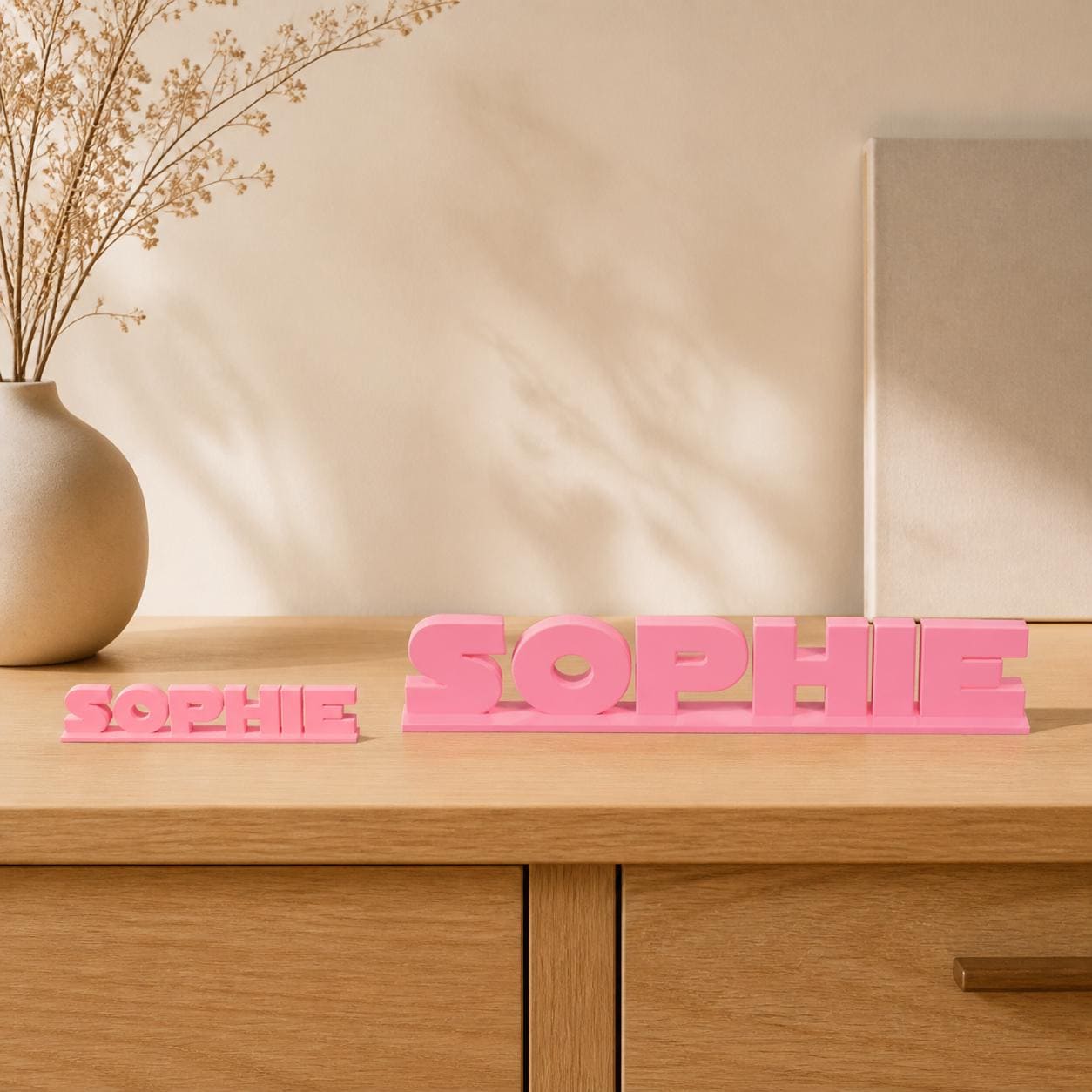 Small and Large Sophie geometric space personalised nameplates shown together for size comparison.