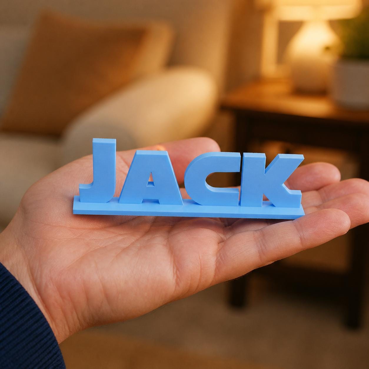 Sophie geometric space personalised nameplate held in an adult hand to demonstrate scale.