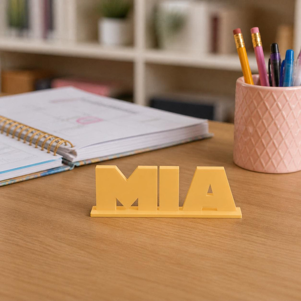 Mia geometric space personalised nameplate displayed on a teacher's desk.