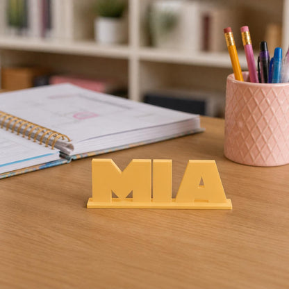 Mia geometric space personalised nameplate displayed on a teacher's desk.