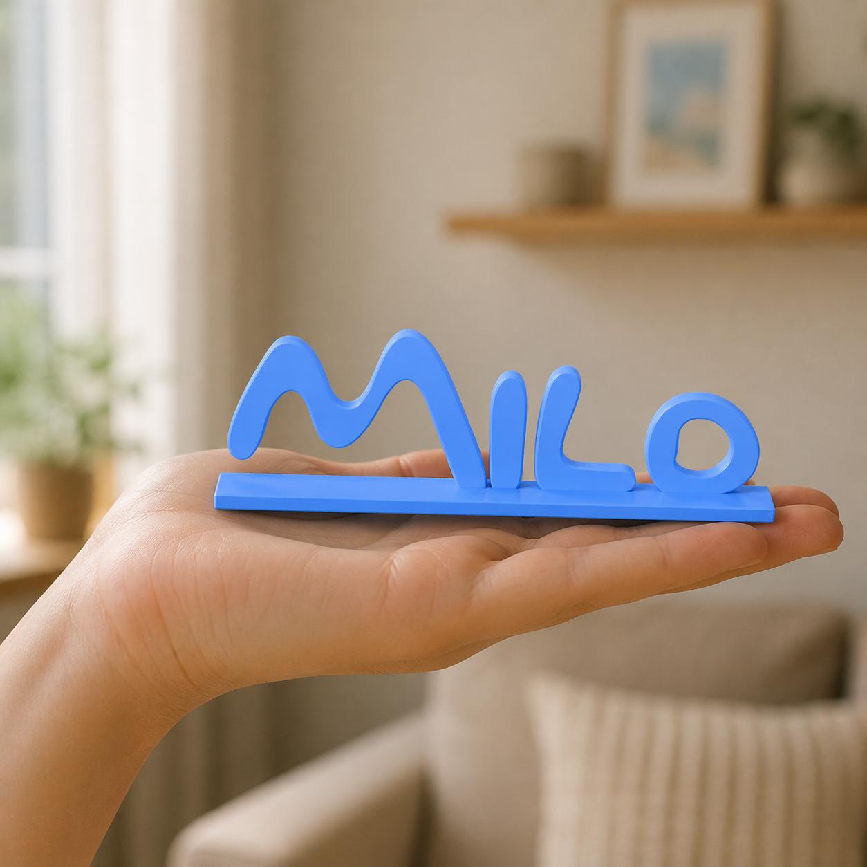 Sophie cartoon style personalised nameplate held in an adult hand to demonstrate scale.