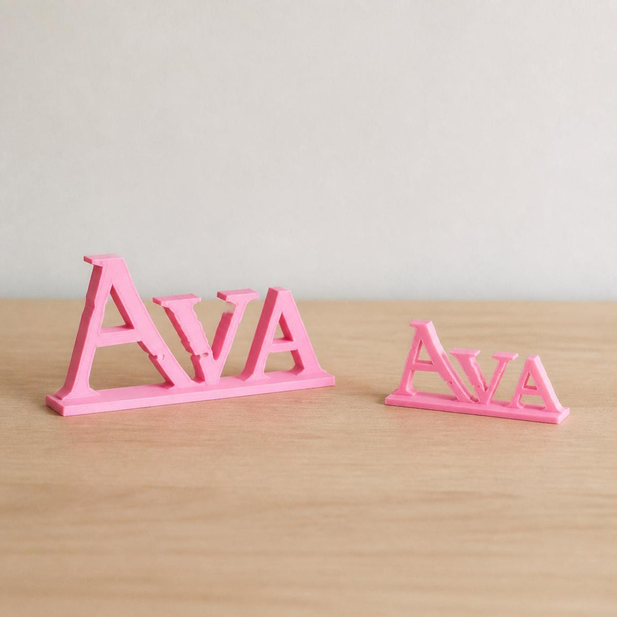 Small and Large Ava epic fantasy personalised nameplates shown together for size comparison.