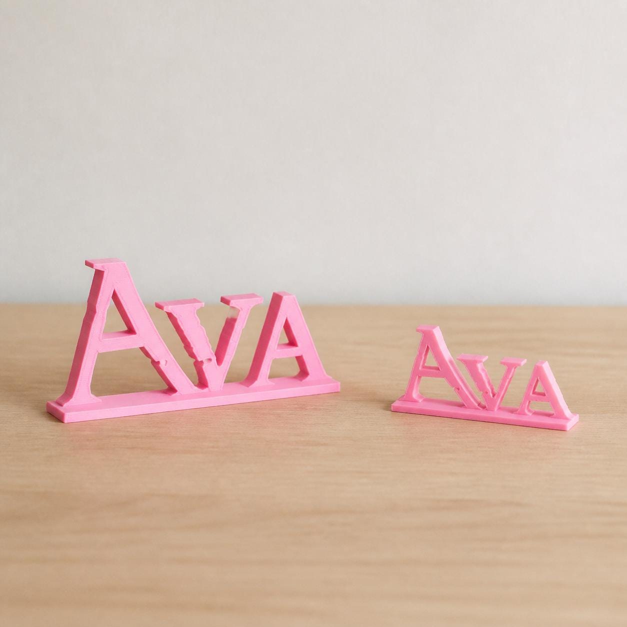 Small and Large Ava epic fantasy personalised nameplates shown together for size comparison.