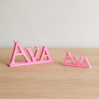 Small and Large Ava epic fantasy personalised nameplates shown together for size comparison.