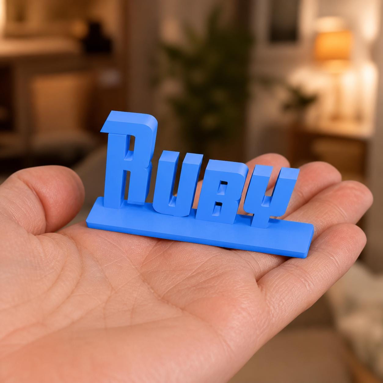 Bella heroic angular personalised nameplate held in an adult hand to demonstrate scale.