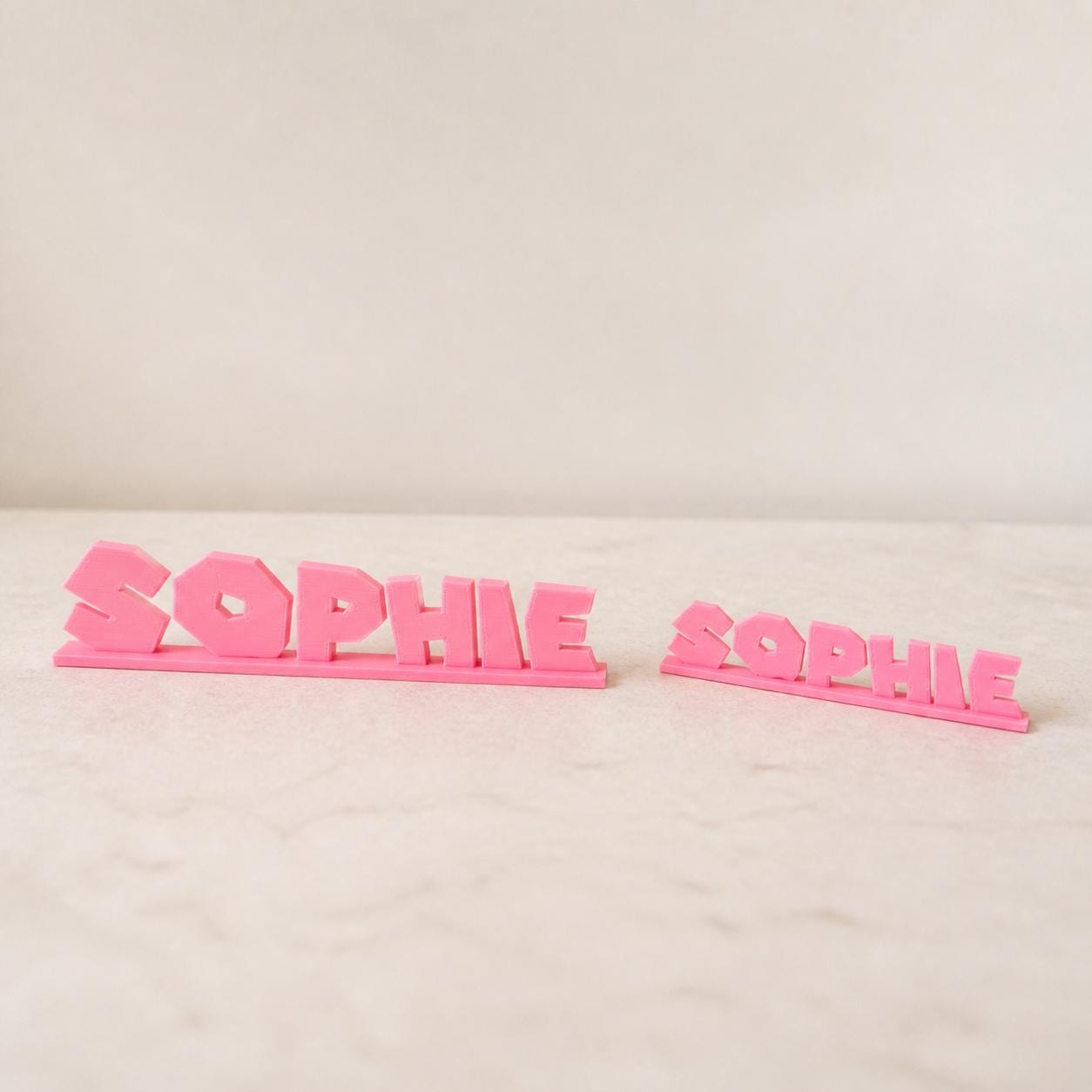 Small and Large Sophie platform adventure personalised nameplates shown together for size comparison.