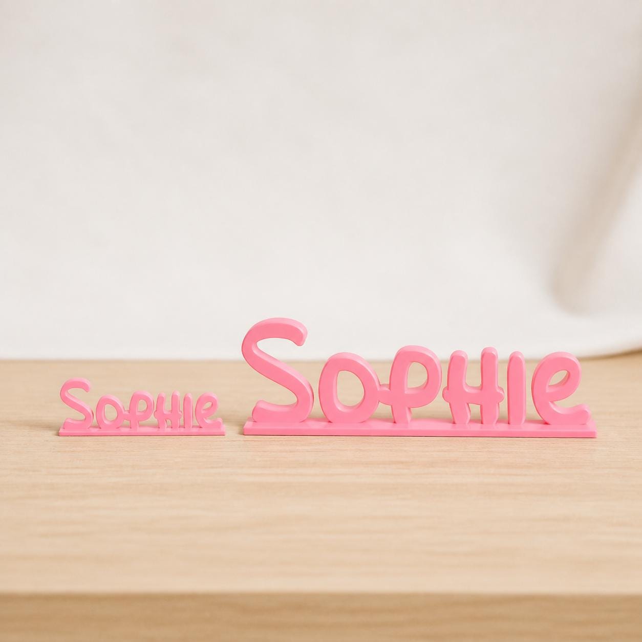 Small and Large Sophie cartoon style personalised nameplates shown together for size comparison.