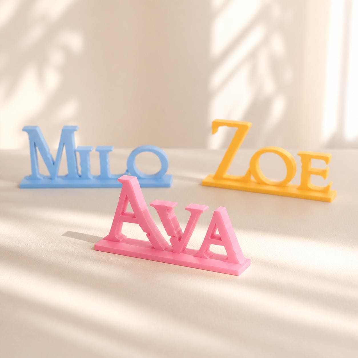 Ava, Milo and Zoe epic fantasy personalised PLA nameplates arranged in a warm neutral studio setting.